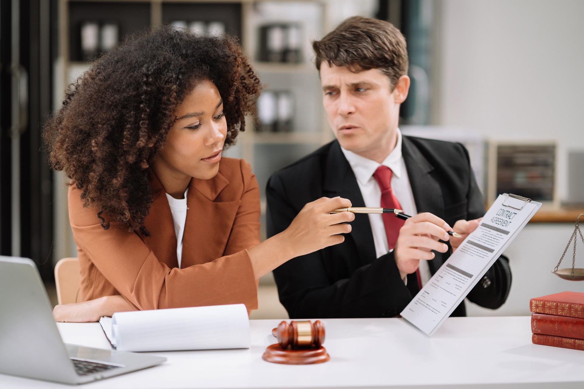 team Legal counsel working with paperwork on his desk in office workplace working with tablet computer. Justice and law concept.